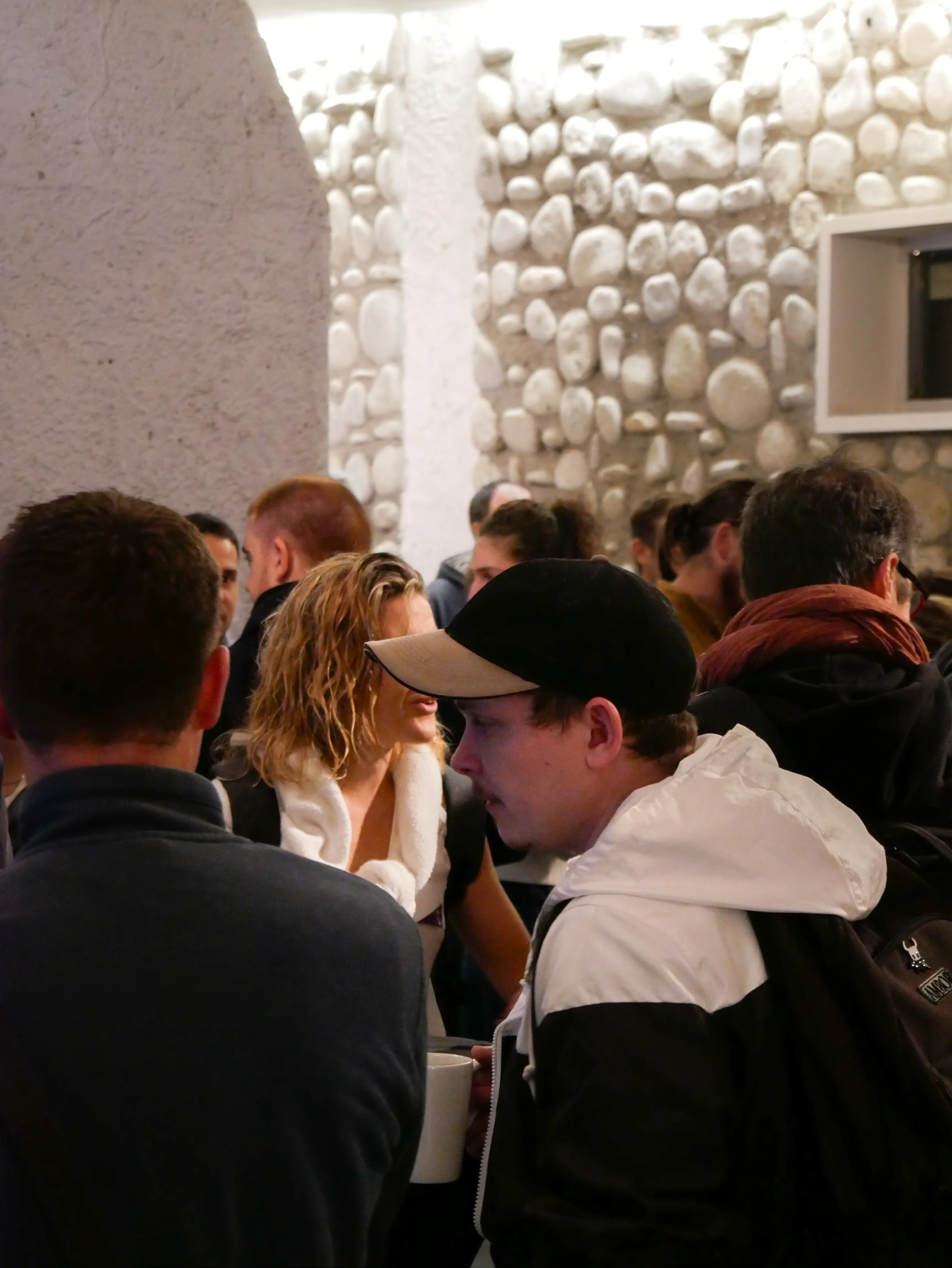 Speaker at podium with projector screen showing presentation slides