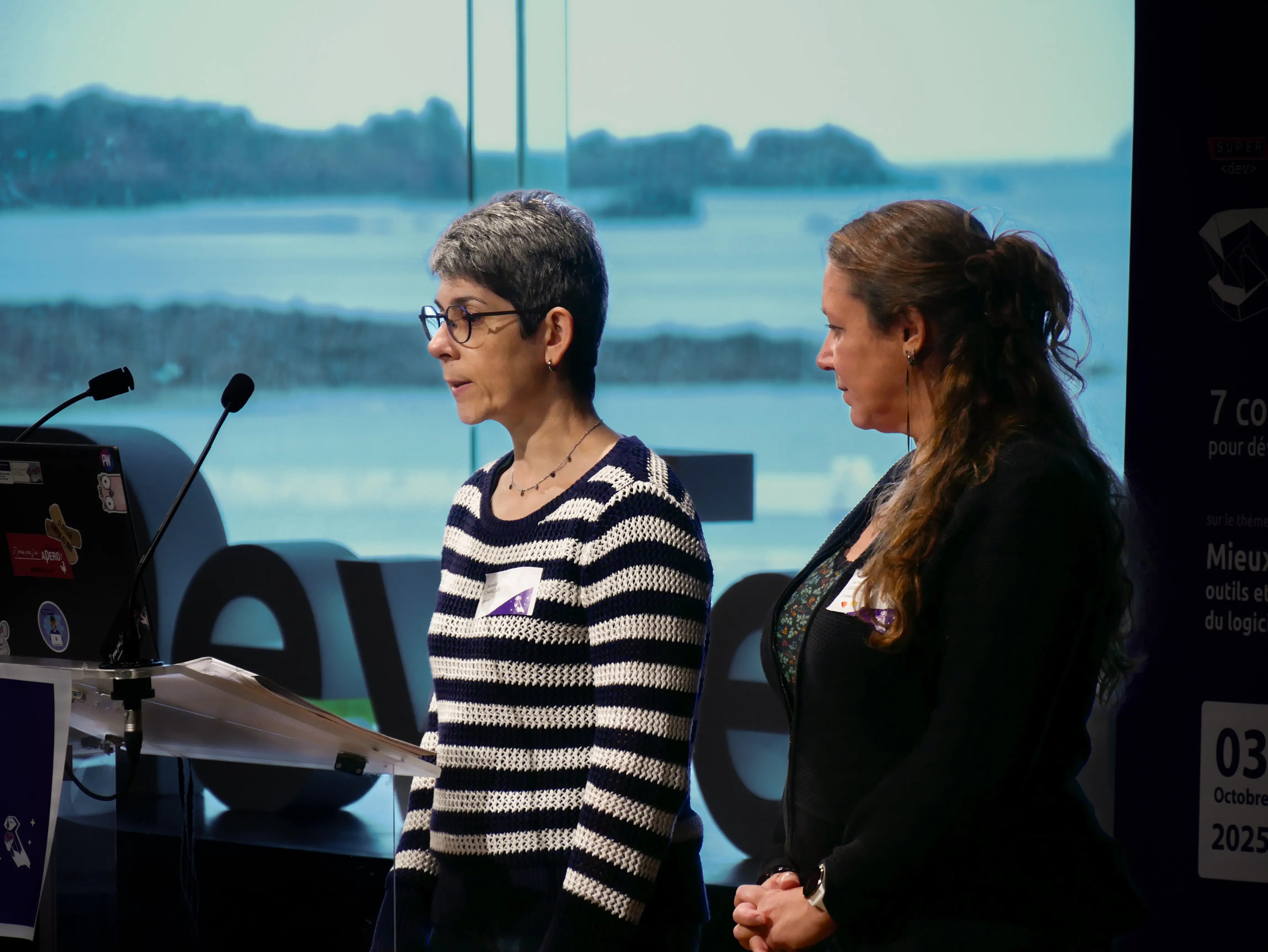 Two women presenting together at the conference podium