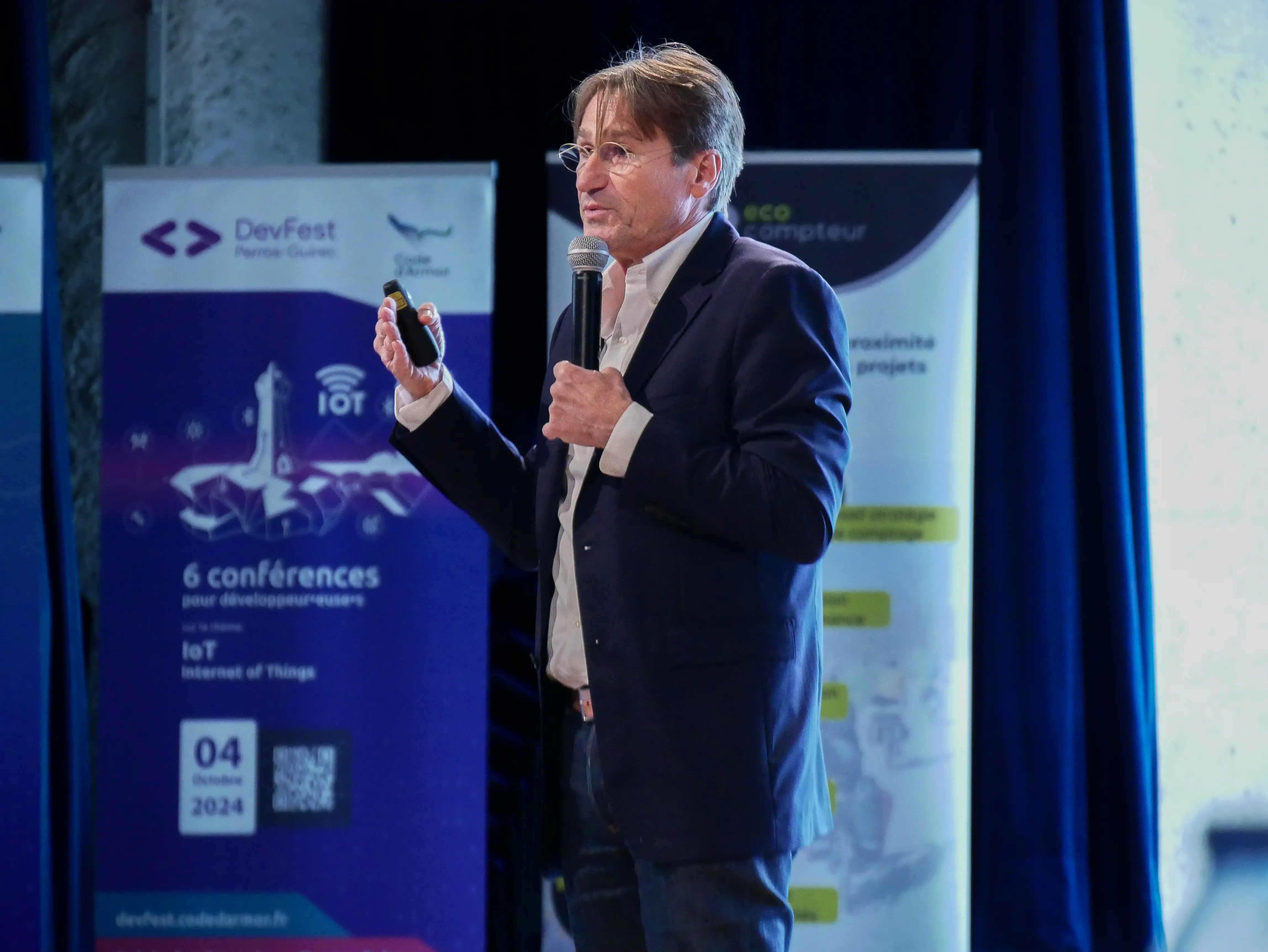 Audience member asking a question using a microphone during Q&A