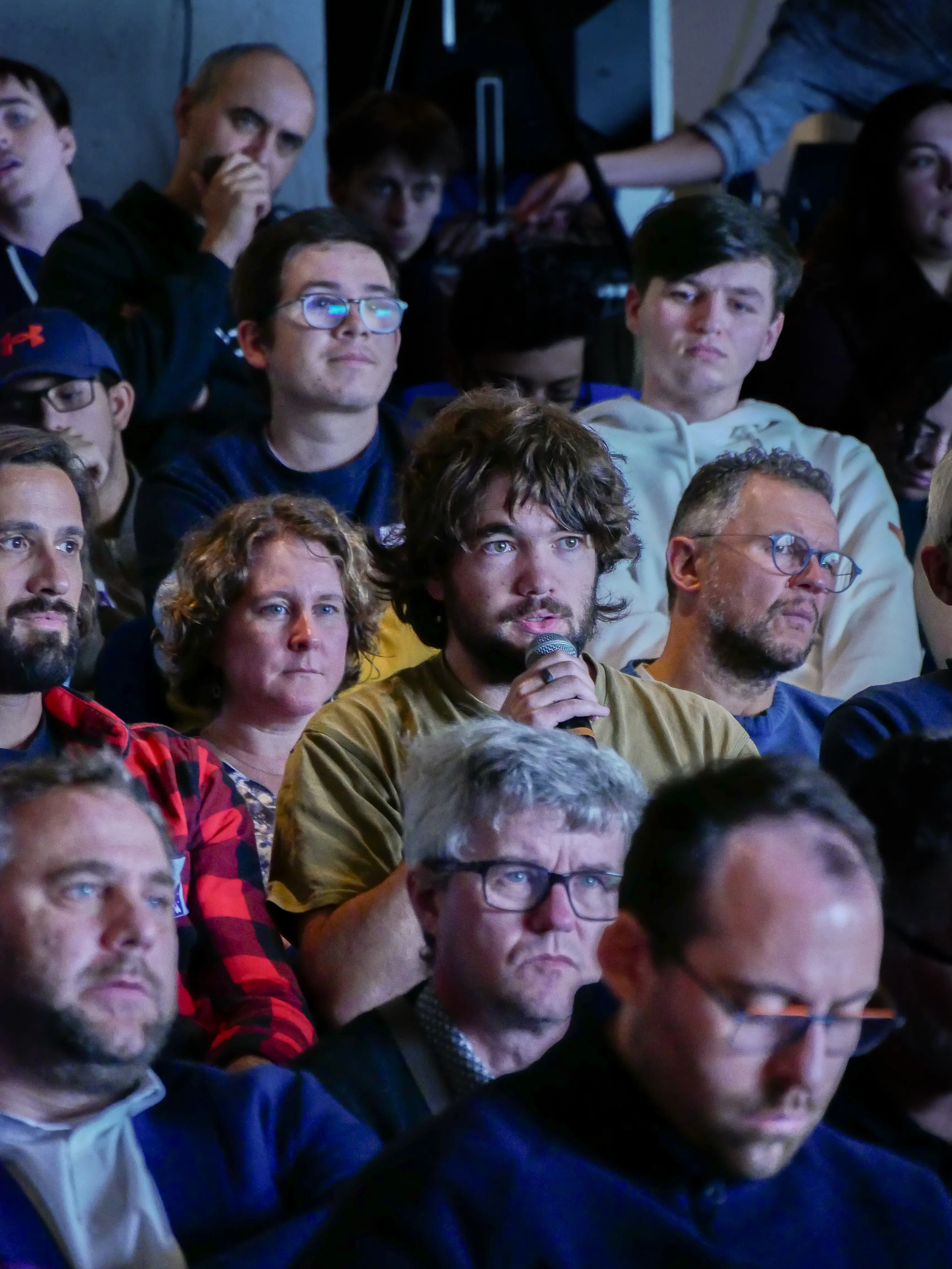 Speaker presenting in front of a large DevFest sign